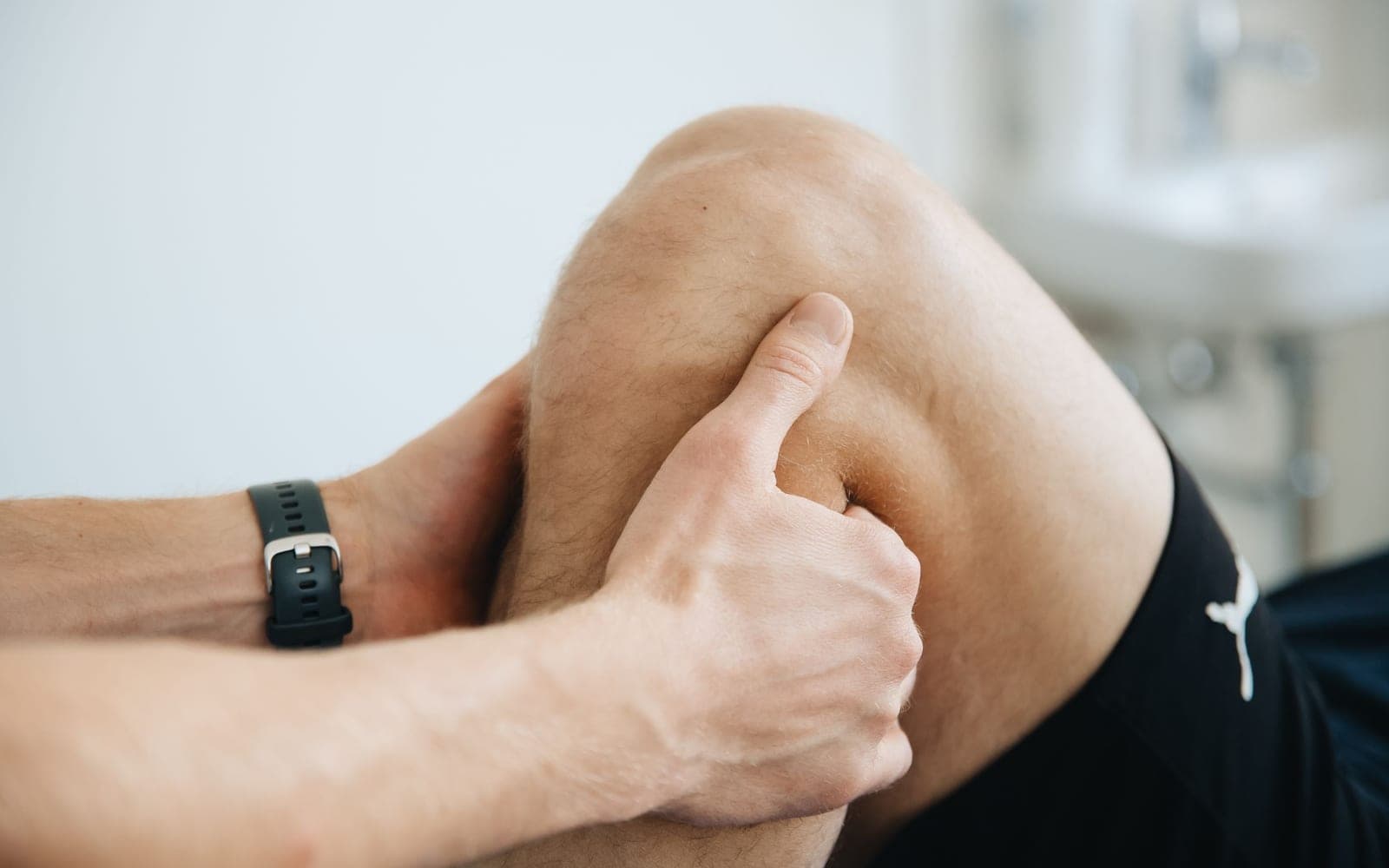 A therapist massaging a runner's knee