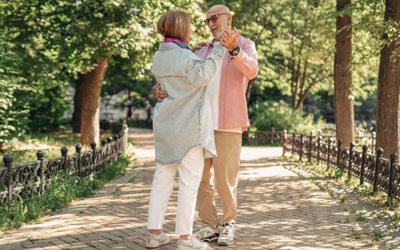 An older couple walking together in a park