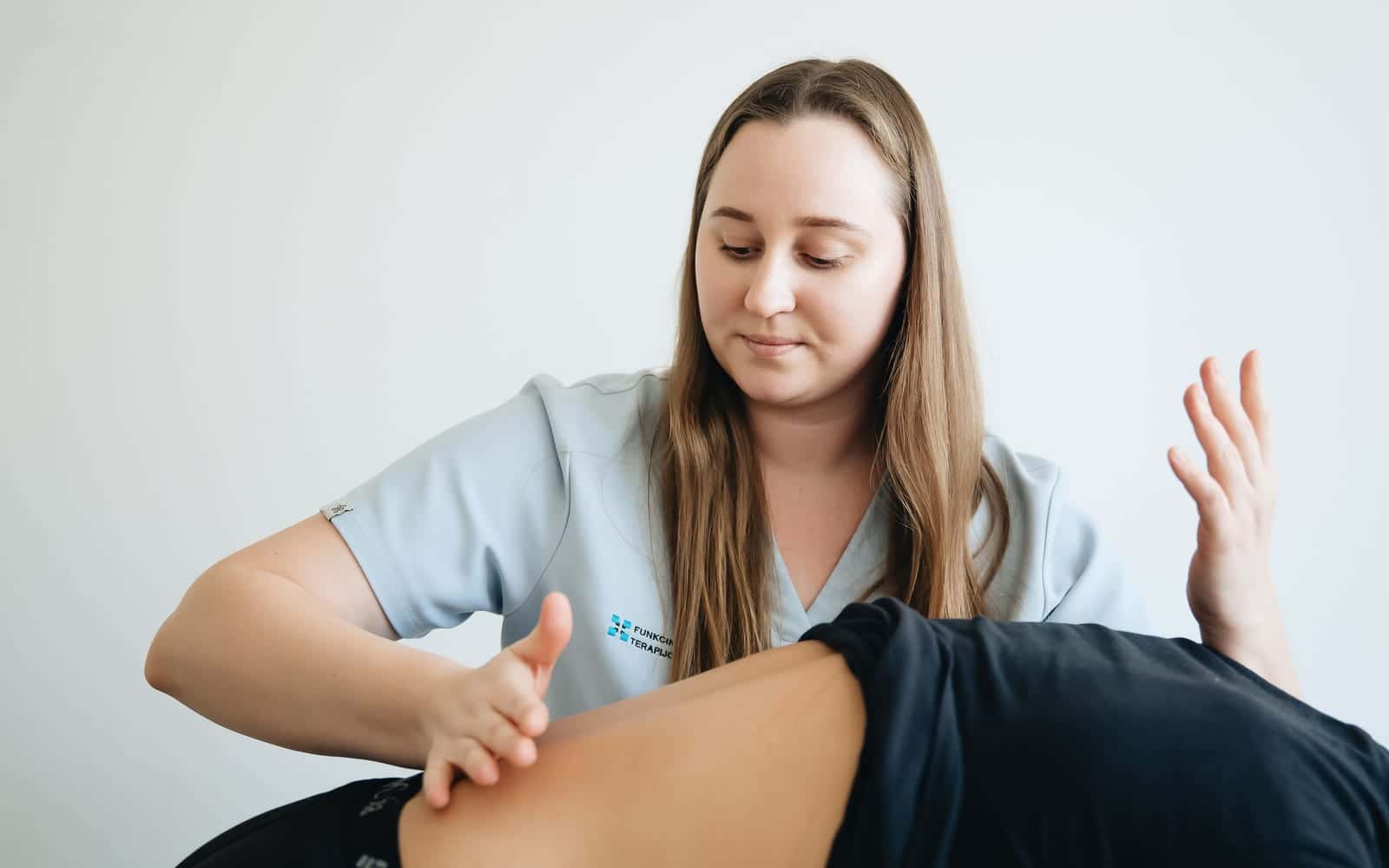 A practitioner examining a patient's lower back