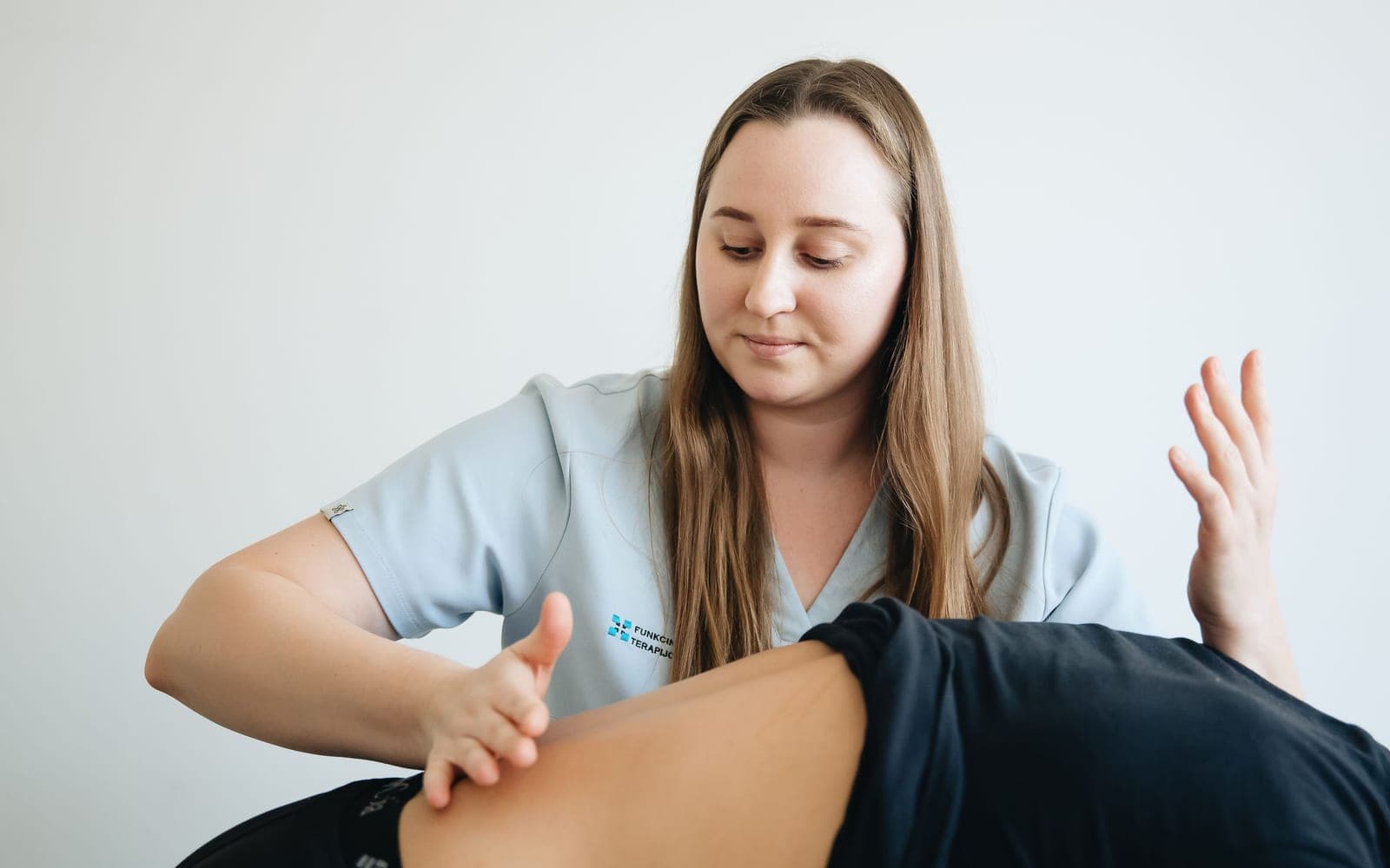 A practitioner examining a patient's lower back