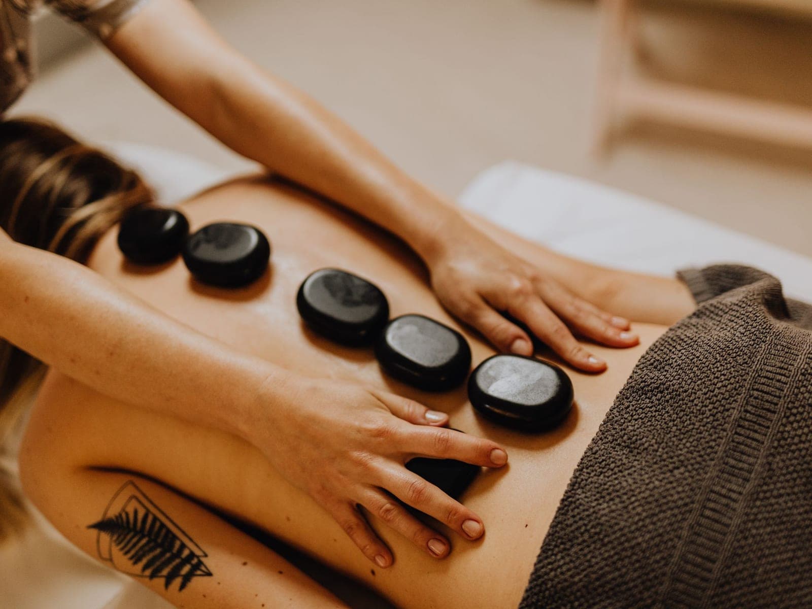 Warm basalt stones placed along a client's back during a hot stone massage