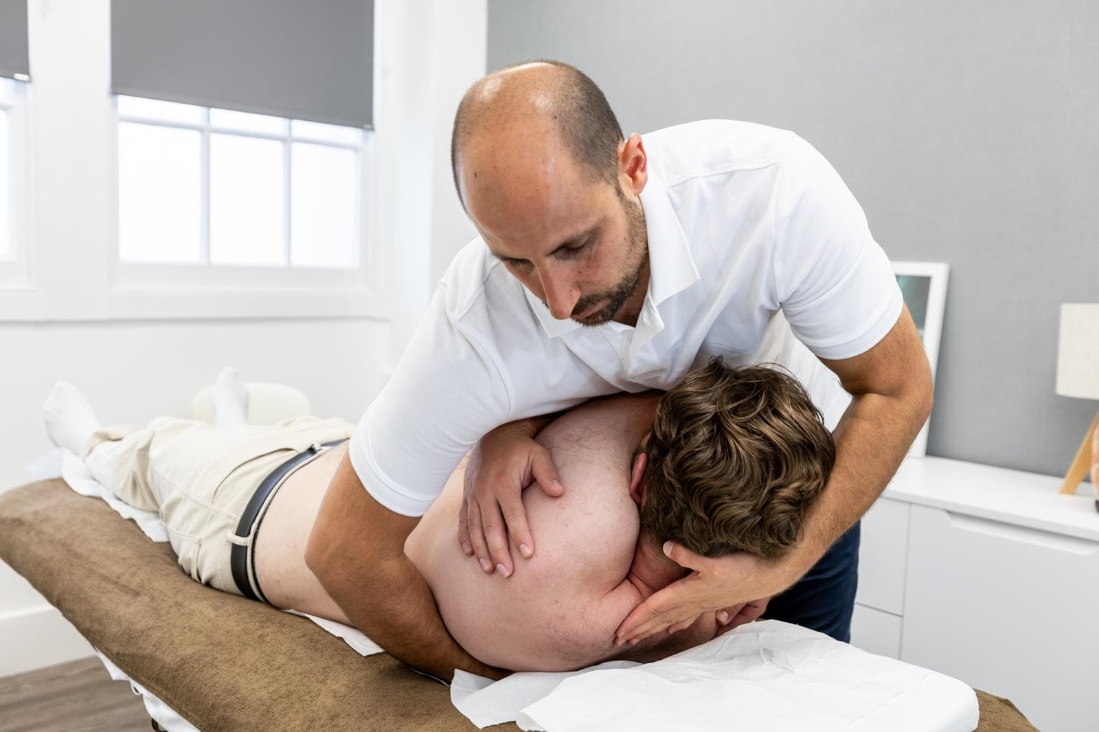 Abdul Abu-Laban treating a patient's neck and shoulder