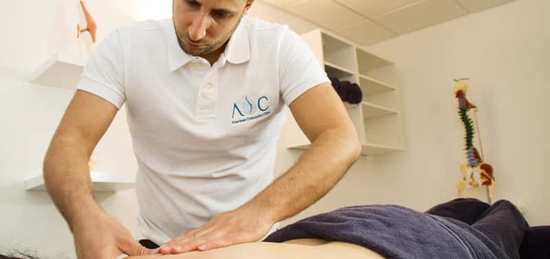 Abdul Abu-Laban treating a patient's back at Aberdeen Osteopathy Clinic